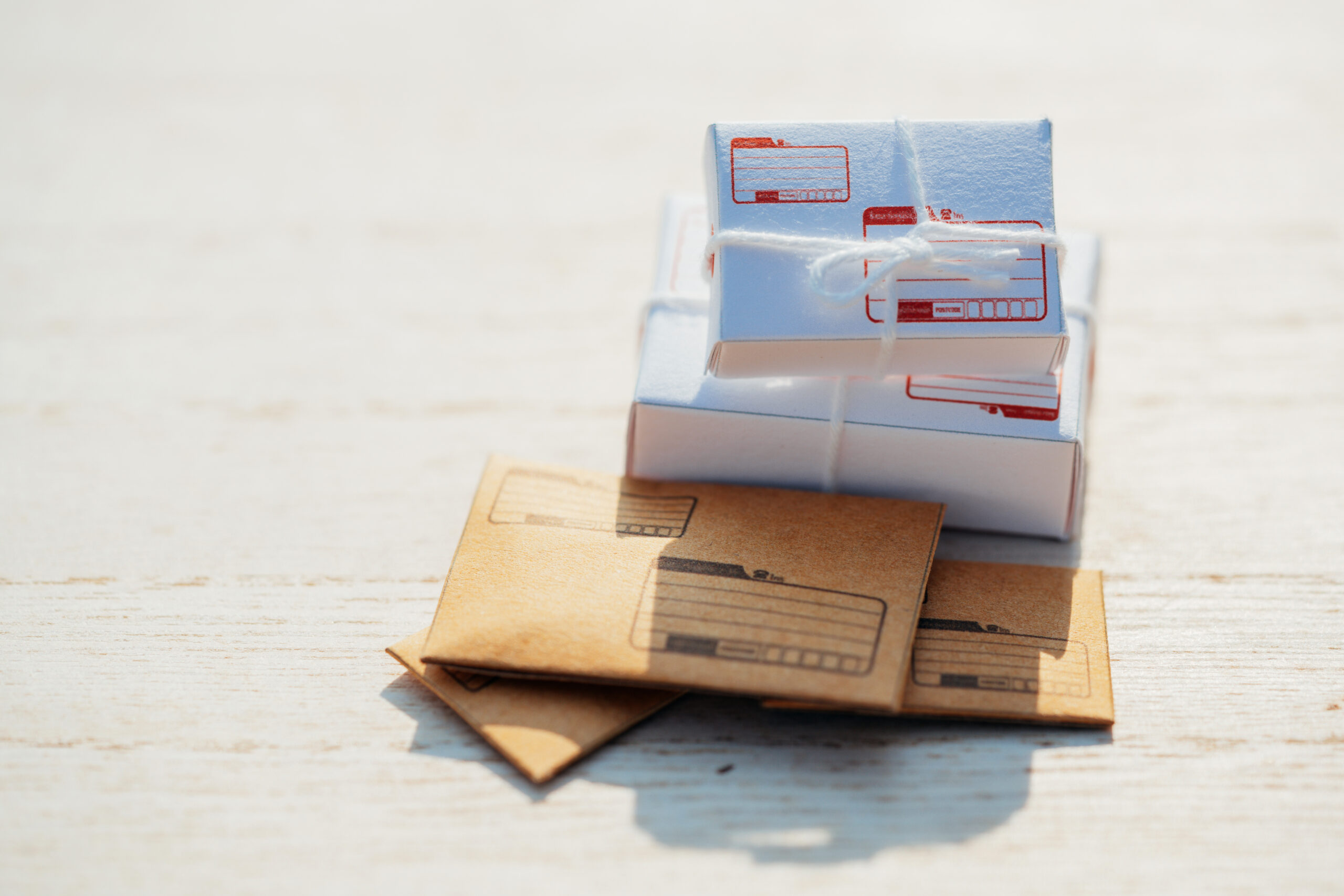 Close up of mail and parcels on a wood grain background.